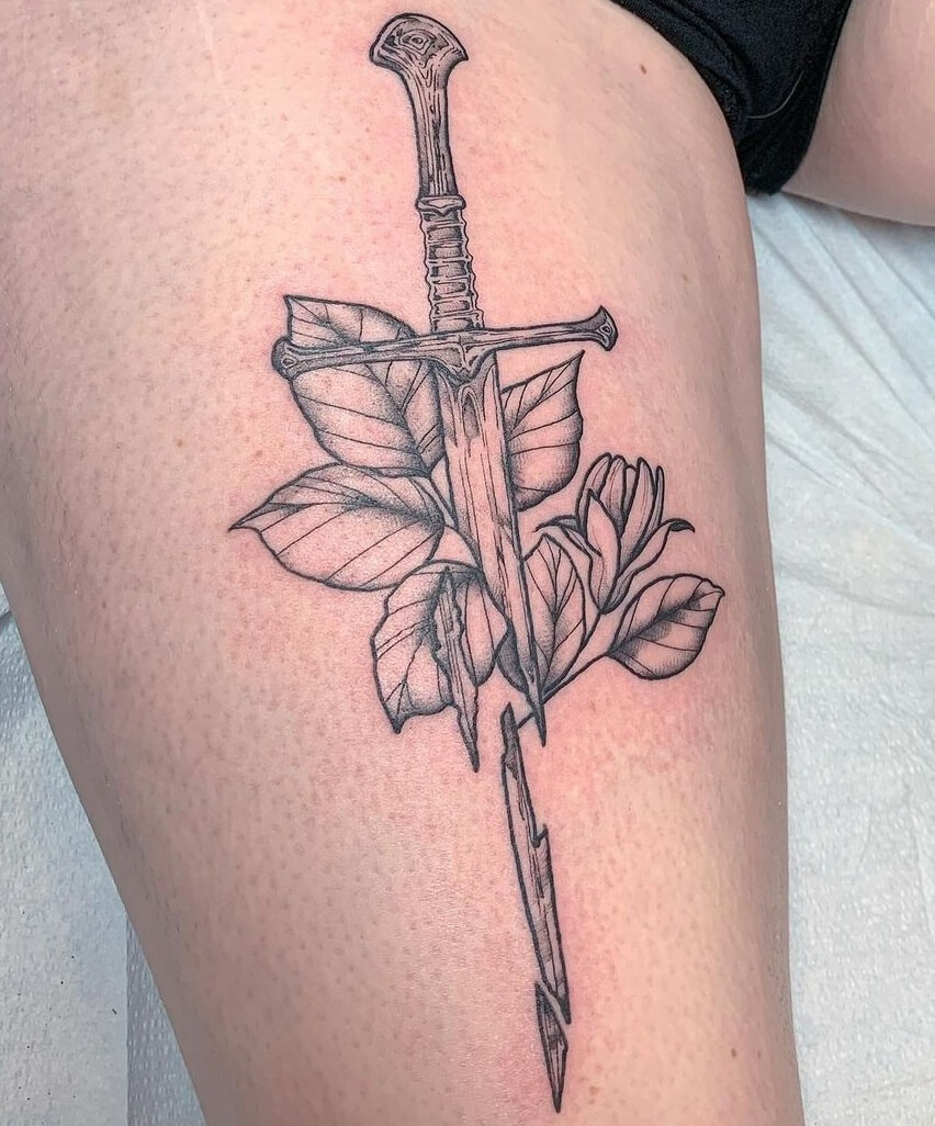 Broken Sword Tattoo Design With Leaves and Flowers